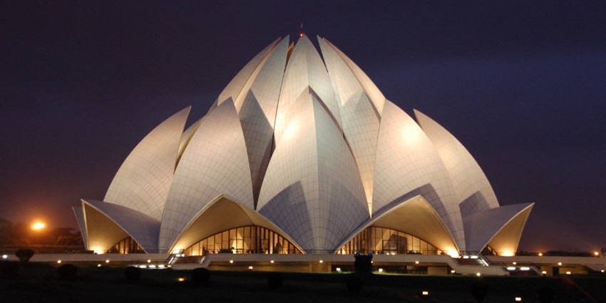 A picture of the Lotus Temple taken from a distance showing its frontal side during nighttime