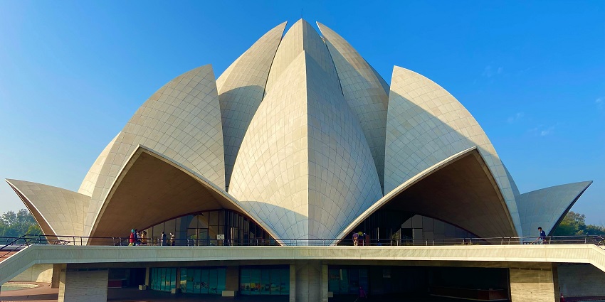 View of the Lotus Temple, showcasing its unique flower-like architecture against a clear sky.