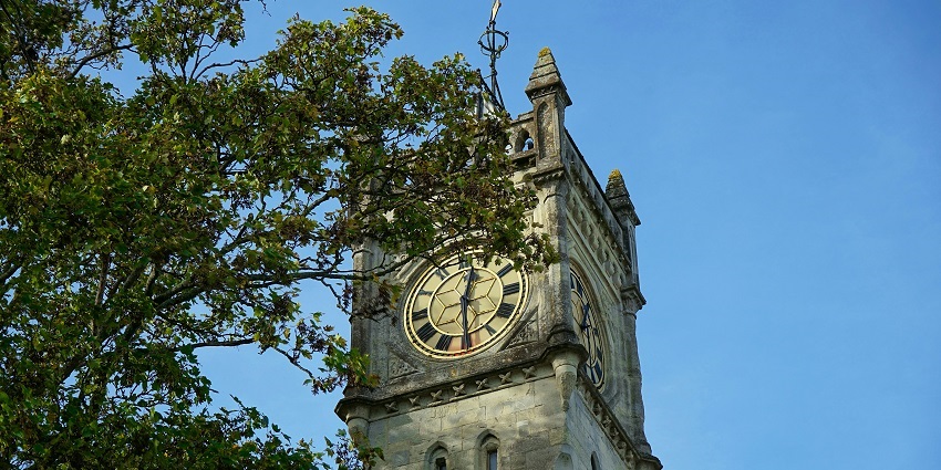 A picture of a tower with a big clock on its face, one of the best places to visit in Ludhiana