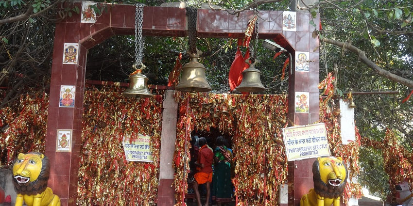 A picture of the entrance of a traditional Hindu temple with statues of lions on both sides