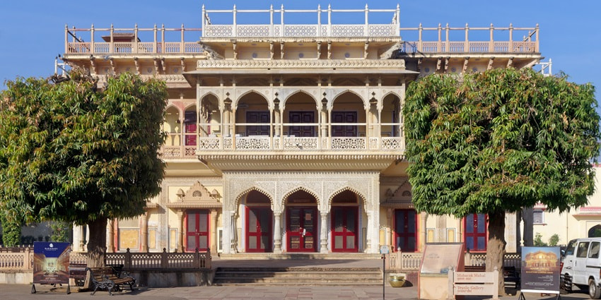 A frontal view of a historical building in Rajasthan coloured in yellow paint