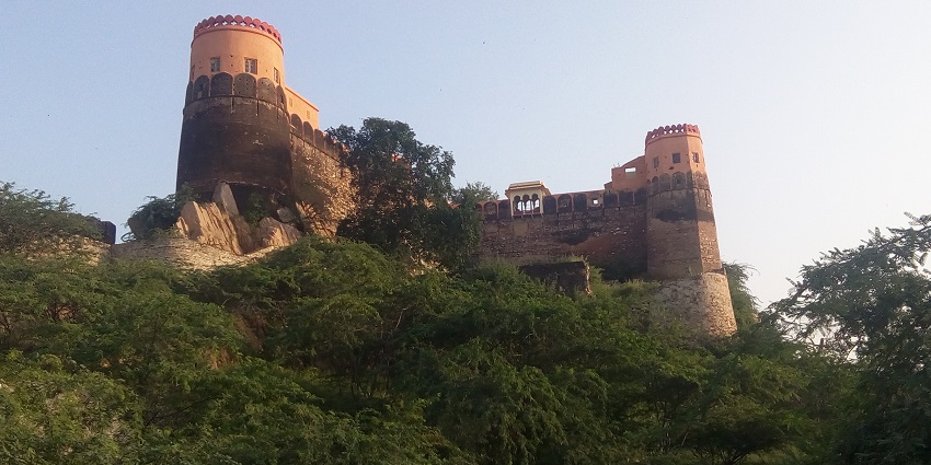 A view of Fort Madhogarh in Rajasthan, showcasing its grand architecture with stone walls.