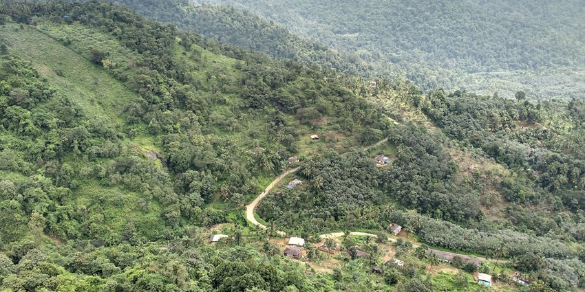 An aerial view of the vast mountains of Madikeri with a blanket of lush greenery all around