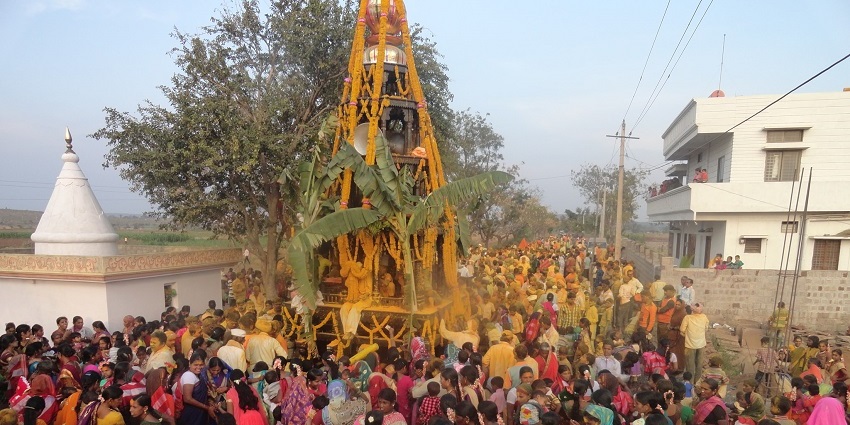 Pilgrims celebrating Mahashivaratri by walking along rathosava saying prayers