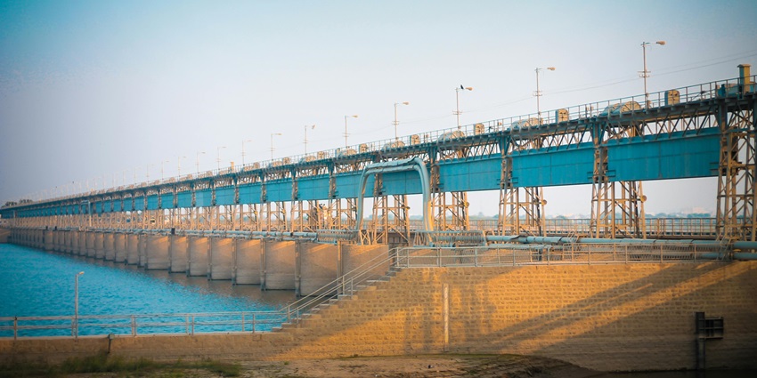 A photo of Mahi Bajaj Sagar Dam, a concrete facility with water flowing over it.