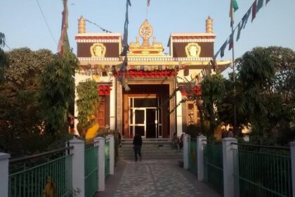 A breathtaking view of a monastery in Majnu Ka Tila with flags on top during the day.