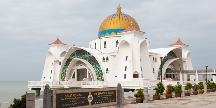 Malacca Straits Mosque against a sunset, a must-see among places to visit near Singapore.