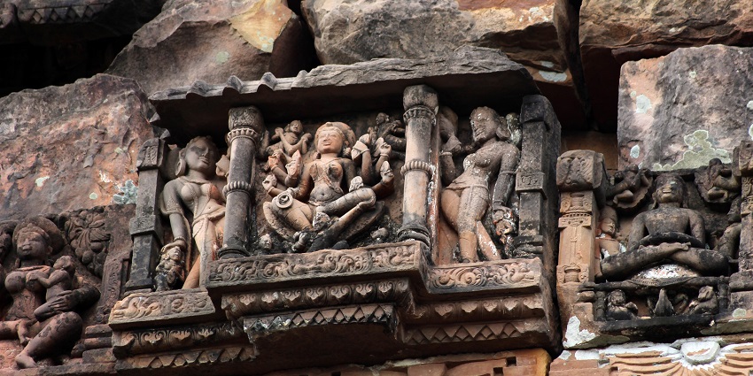 An image of the Maladevi temple featuring intricate carvings and pillars from the early centuries.