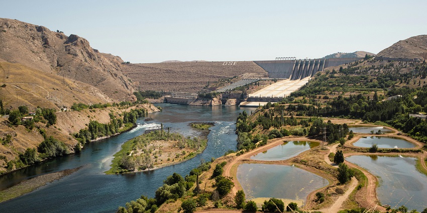 Wide angle view of the water rushing through dam creating misty effect at the bottom