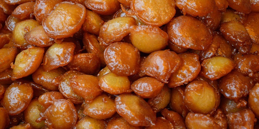 Malpua is a deep-fried pancake in sugar syrup, served with sweet rabri.