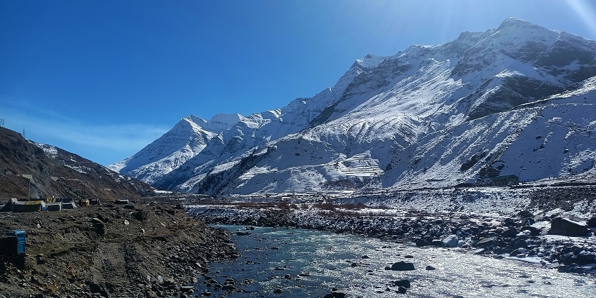 Image of Sisu, Manali with snow covered mountains, twisty road around and a river