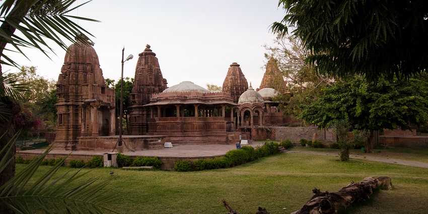 Ancient gardens with royal cenotaphs and temples, whispering shadows at dusk