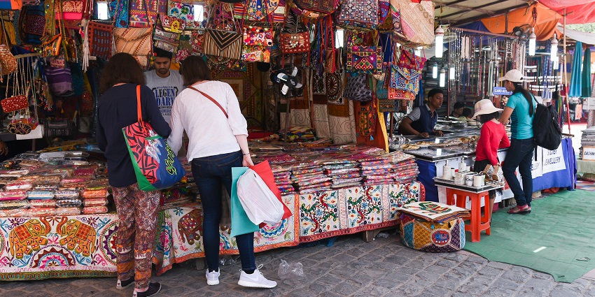 Shops displaying various types of clothing for all visitors in a narrow street