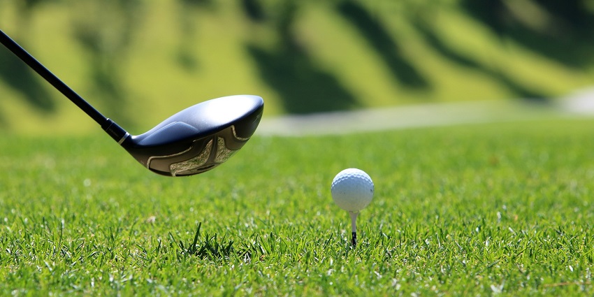 Snapshot of a golfer taking a shot on the Golf ball— Places To Visit in Manesar