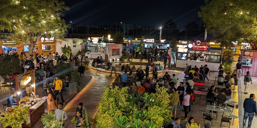 A picture of a crowded food court in Mansarovar taken during night time, with numerous street food stalls all around
