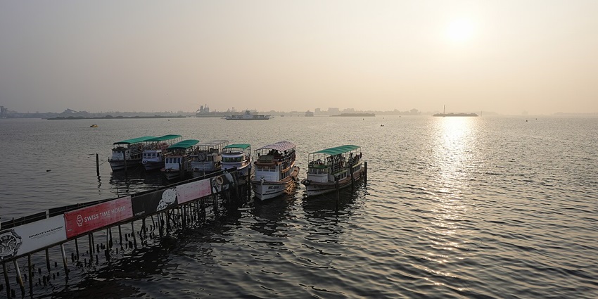 Boats lined up at the Marine Drive jetty, offering backwater tours in Kochi.