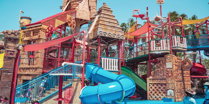 Vibrant water slides at the Marvel Water Park with a shimmering pool below