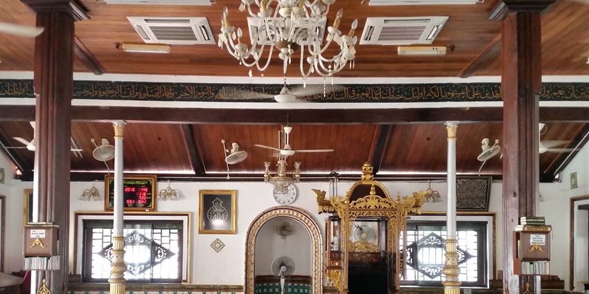 Historic Malacca mosque with tiered roof, Chinese-Malay architecture, and vibrant prayer space dating back to the early 18th century, one of the best mosques in Malaysia.