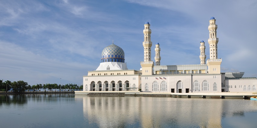 Royal mosque in Bukit Jelutong with grand domes, elegant arches, and serene surroundings reflecting Islamic architecture and spiritual heritage.