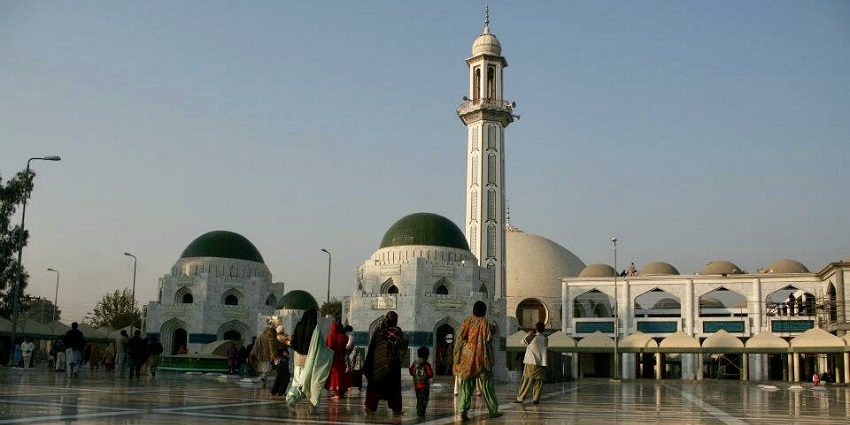 A family walking towards the mosque to take part in the afternoon prayer for a serene experience