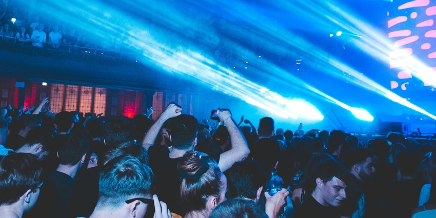 Lively nightclub featuring vibrant lighting, upbeat music, and a youthful crowd enjoying themed party nights.