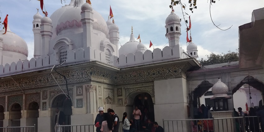 View inside the temple courtyard with devotees walking around in the serene atmosphere
