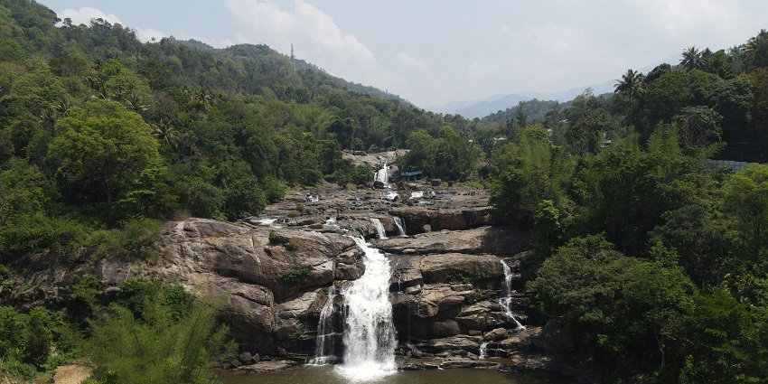 A picture of one of the best places to visit in Araku with a beautiful waterfall cascading down a hill