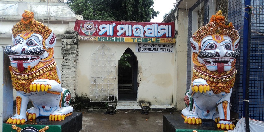Two majestic lion statues stand guard in front of a Mausima Temple.