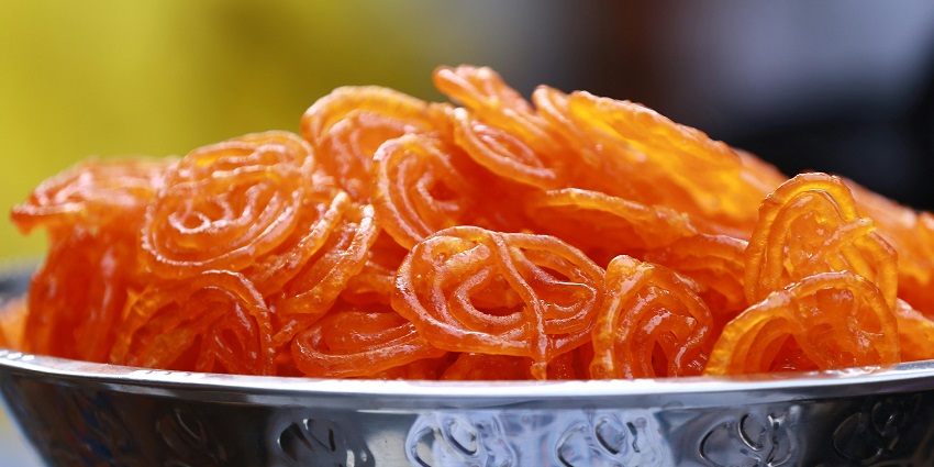 Thick golden Mawa Jalebis made with condensed milk, glistened with syrup, are a must-try.