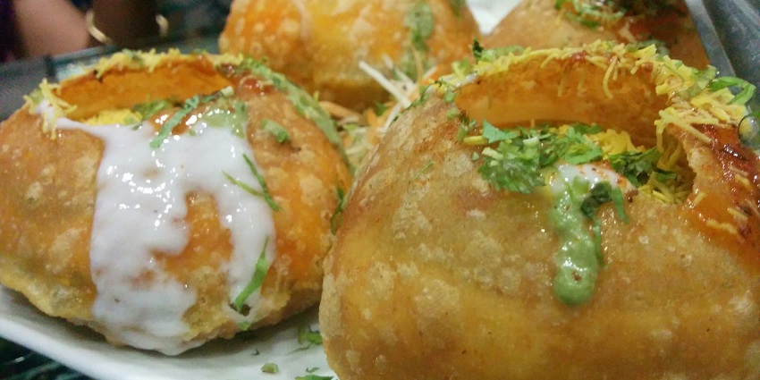 An image of Mawa Kachori: sweet, deep-fried pastry filled with mawa and dry fruits.