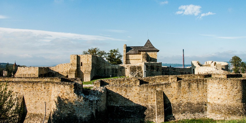 Image of ancient fort wall ruins under clear blue sky and white clouds and serene weather