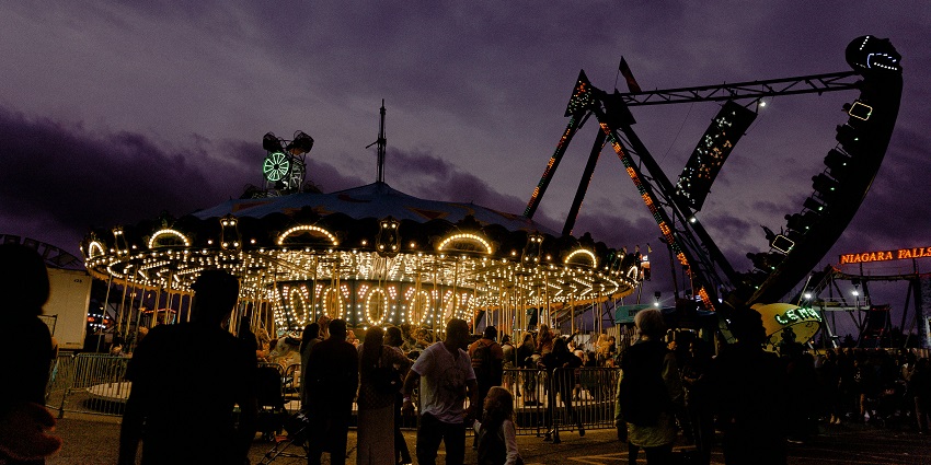 People enjoying rides at a lively amusement park like the Mela Ground in Pushkar.