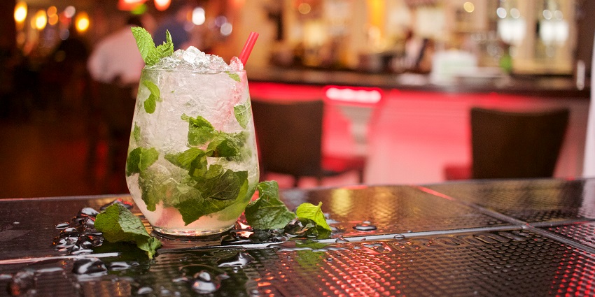 A picture of a glass of cocktail served on a bar counter at a nightlife place in Nana Plaza