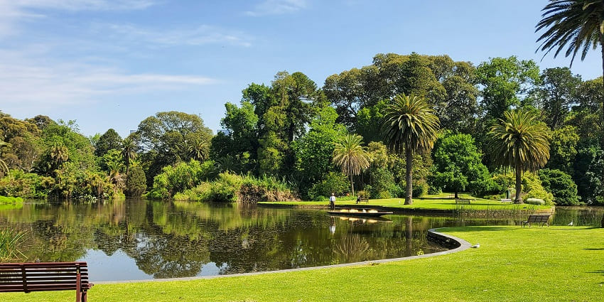 A quaint vista of Mirasol Lake Garden filled with lush green trees and a serene lake.