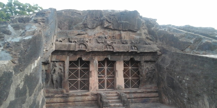 Image of ancient rock-cut caves in Mogalarajapuram, showcasing intricate sculptures.