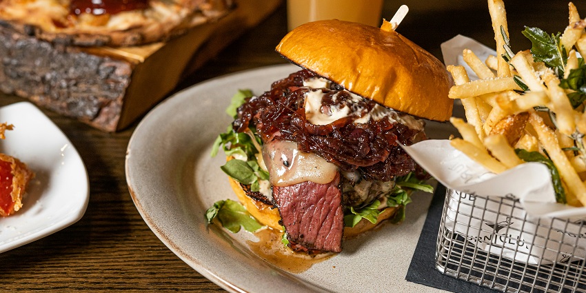 Image of burger and fries on the side, delectable food in bar one can enjoy - Delhi nightlife for singles