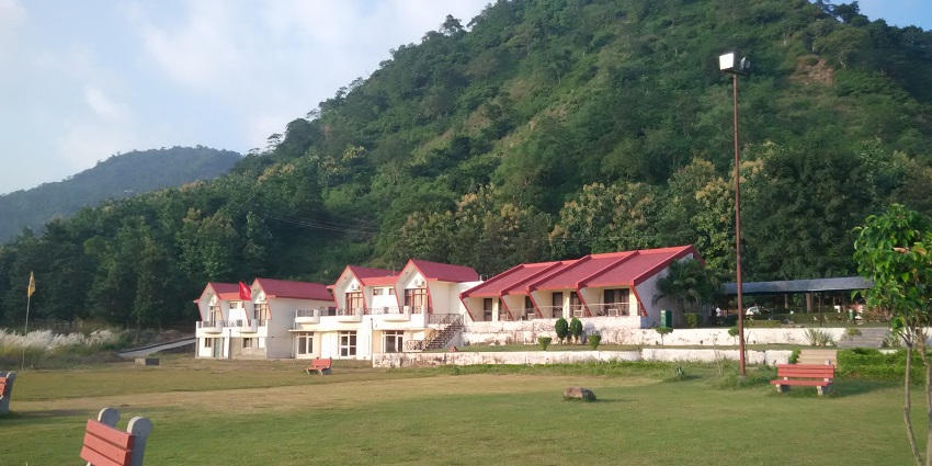 Morni Hills with Tikkar Taal in Haryana, showcasing lush greenery and serene water reflecting the sky