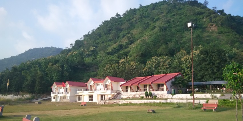 View of Morni Hills and Tikkar Taal in Haryana, showcasing lush greenery and serene waters.