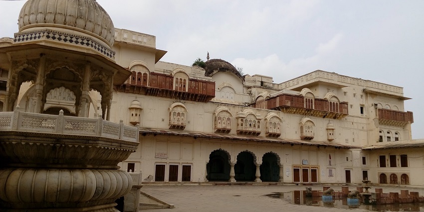 The dome of the Moti Dungari fort, surrounded by a beautiful garden and lush trees in Jaipur