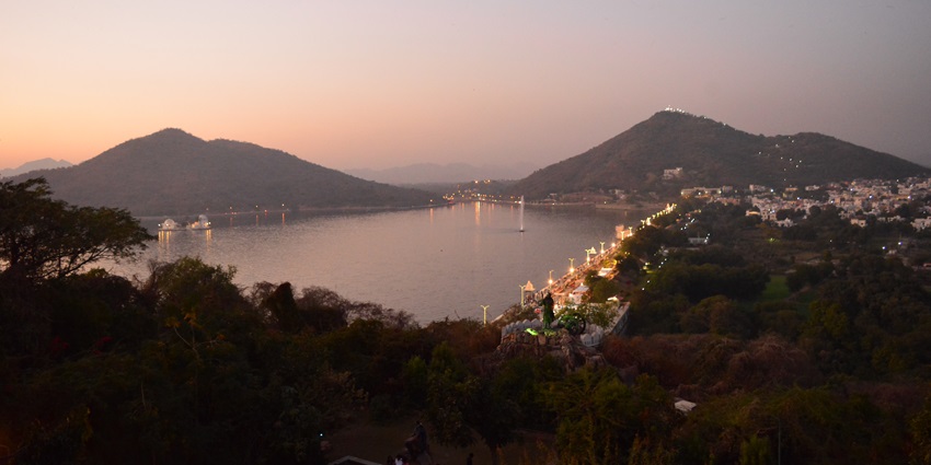 A mesmerising view of the skyline of the city of Udaipur seen from Moti Magri, glowing under night lights.