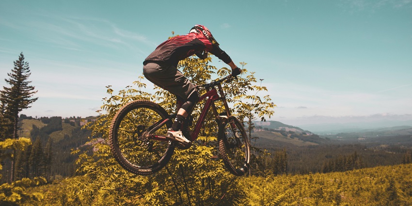 Cyclists riding rugged mountain trails for famous adventure sports in Nepal for everyone.