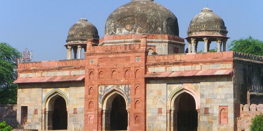 A beautiful red mosque, in the midst of a beautiful, well-kept garden in Gujarat