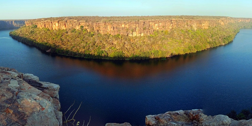 A deep gorge carved by the Chambal River, surrounded by rugged hills and sparse vegetation.