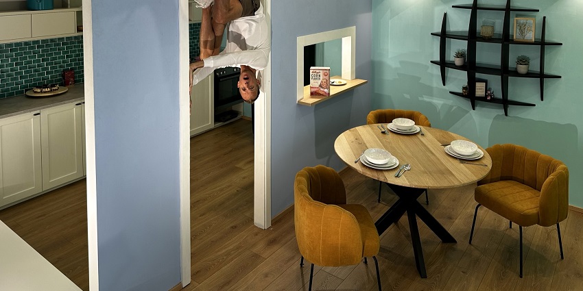 A picture of a man creating illusions by making it look like he's sitting upside down