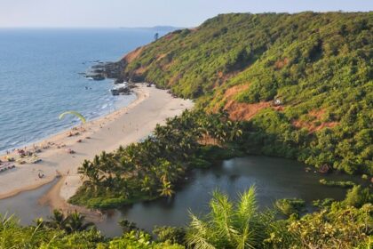 A breathtaking view of an azure water body with a lush green island on the side.