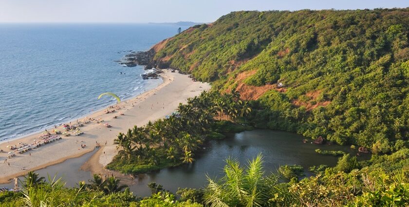 A breathtaking view of an azure water body with a lush green island on the side.