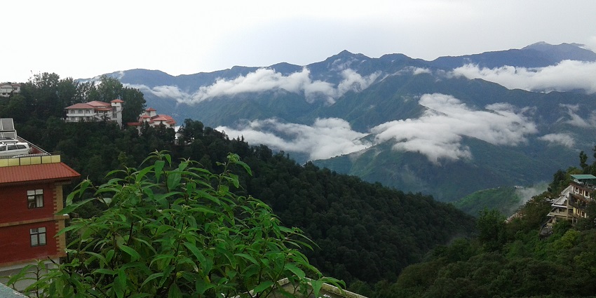 View of Mussoorie hill station in india surrounded by lush greenery and misty weather