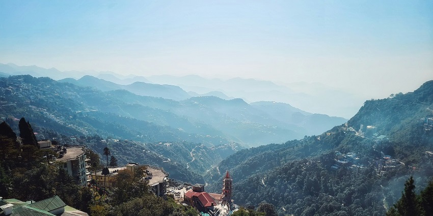 Scenic view of Mussoorie, Uttarakhand, showcasing lush hills and vibrant greenery.