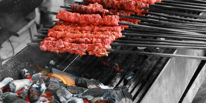 Seekh Kebabs being toasted over the open coal Grill on the tandor