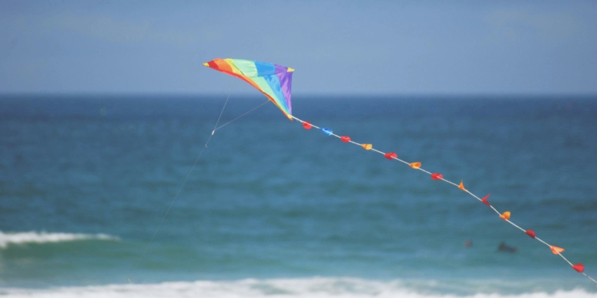 View of the kite festival at the sandy shore and placid waves is a unique experience here.
